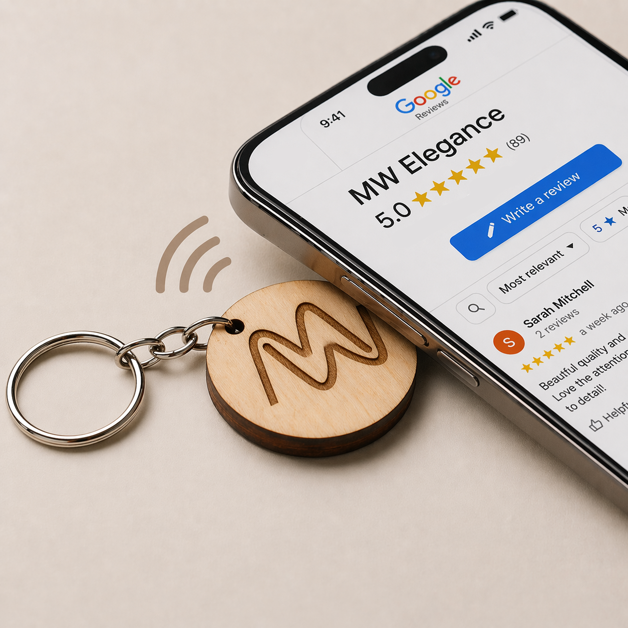 Phone tapping wooden NFC keychain to open Google Reviews page for MW Elegance